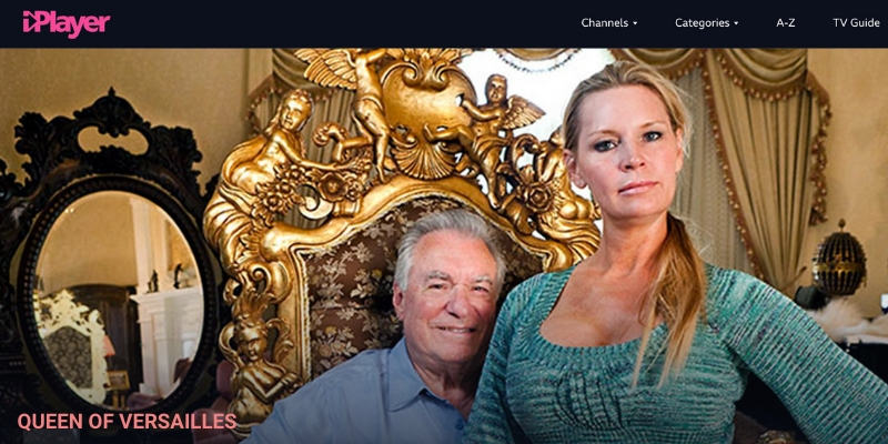 Movie still from QUEEN OF VERSAILLES. A Woman sits on a man's lap. The man sits of a gold throne