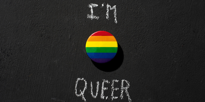 I'm Queer writing on a blackboard