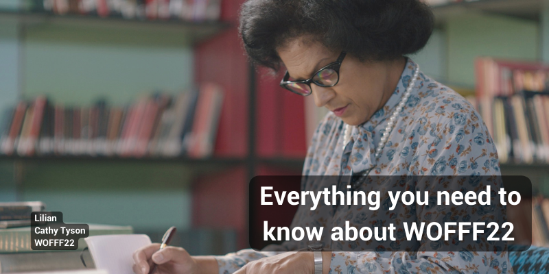 An older women wearing spectacles sits writing at a desk. Text says: Everything you need to know about WOFFF22. Image caption: Lilian Cathy Tyson WOFFF22